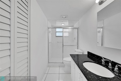 This stunning corner unit features high-quality waterproof vinyl on Wynmoor Golf Course in Florida - for sale on GolfHomes.com, golf home, golf lot