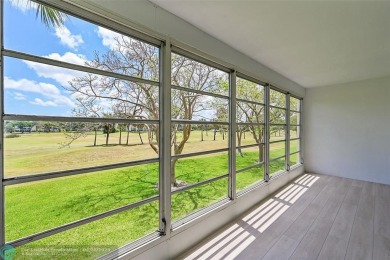 This stunning corner unit features high-quality waterproof vinyl on Wynmoor Golf Course in Florida - for sale on GolfHomes.com, golf home, golf lot