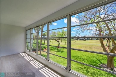 This stunning corner unit features high-quality waterproof vinyl on Wynmoor Golf Course in Florida - for sale on GolfHomes.com, golf home, golf lot