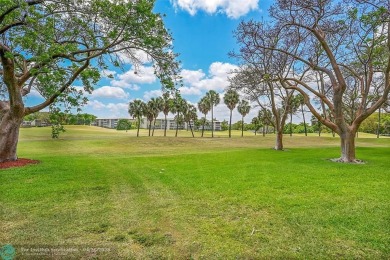 This stunning corner unit features high-quality waterproof vinyl on Wynmoor Golf Course in Florida - for sale on GolfHomes.com, golf home, golf lot