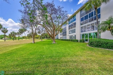 This stunning corner unit features high-quality waterproof vinyl on Wynmoor Golf Course in Florida - for sale on GolfHomes.com, golf home, golf lot