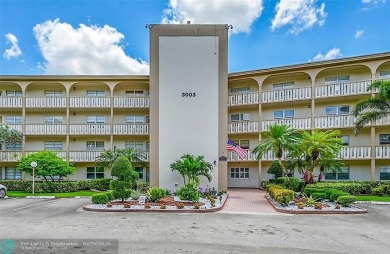 This stunning corner unit features high-quality waterproof vinyl on Wynmoor Golf Course in Florida - for sale on GolfHomes.com, golf home, golf lot