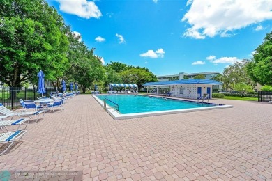 This stunning corner unit features high-quality waterproof vinyl on Wynmoor Golf Course in Florida - for sale on GolfHomes.com, golf home, golf lot