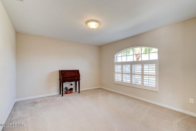 This stunning 3-bedroom plus den/office , 2-bath home is located on Spruce Creek Golf Club in Florida - for sale on GolfHomes.com, golf home, golf lot