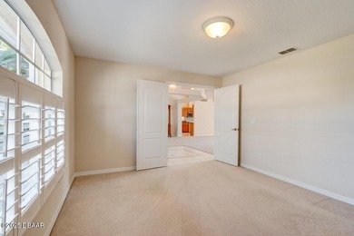 This stunning 3-bedroom plus den/office , 2-bath home is located on Spruce Creek Golf Club in Florida - for sale on GolfHomes.com, golf home, golf lot