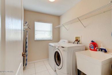 This stunning 3-bedroom plus den/office , 2-bath home is located on Spruce Creek Golf Club in Florida - for sale on GolfHomes.com, golf home, golf lot