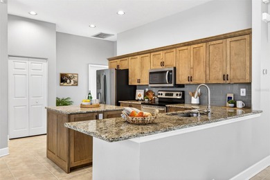 Situated on a rare 10,000+ sq ft lot in Westchase, this heated on Westchase Golf Club in Florida - for sale on GolfHomes.com, golf home, golf lot