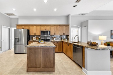 Situated on a rare 10,000+ sq ft lot in Westchase, this heated on Westchase Golf Club in Florida - for sale on GolfHomes.com, golf home, golf lot