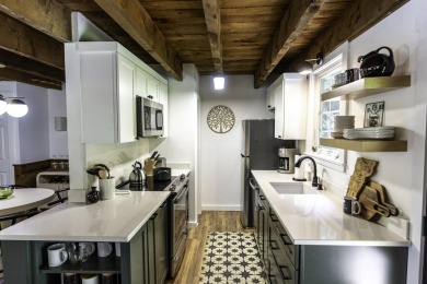 This beautifully reimagined Quechee Hollow end unit is turnkey! on Quechee Club in Vermont - for sale on GolfHomes.com, golf home, golf lot