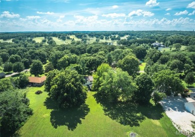 This stunning 2-story home offers 4 bedrooms, 2 full baths, and on Oak Meadow Country Club in Missouri - for sale on GolfHomes.com, golf home, golf lot