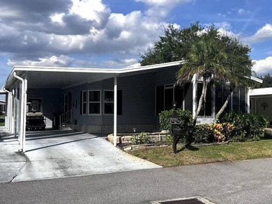 This stunning 2 bedroom, 2 bath home has been thoughtfully on Lake Henry Golf Club in Florida - for sale on GolfHomes.com, golf home, golf lot