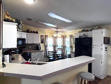 This stunning 2 bedroom, 2 bath home has been thoughtfully on Lake Henry Golf Club in Florida - for sale on GolfHomes.com, golf home, golf lot
