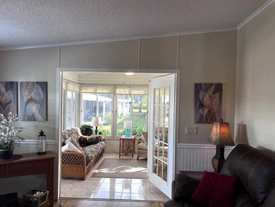 This stunning 2 bedroom, 2 bath home has been thoughtfully on Lake Henry Golf Club in Florida - for sale on GolfHomes.com, golf home, golf lot