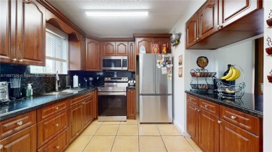 This beautifully updated condo in Bonita Golf View Villas is on Country Club of Miami in Florida - for sale on GolfHomes.com, golf home, golf lot