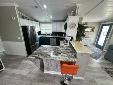 Lot Rent $1075 monthly     This beautiful 2-bedroom, 2 bathroom on Del Tura Golf and Country Club in Florida - for sale on GolfHomes.com, golf home, golf lot