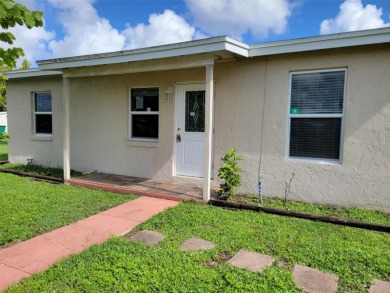 Solidly-constructed, compact home with tile floors throughout on Port Charlotte Golf Club in Florida - for sale on GolfHomes.com, golf home, golf lot