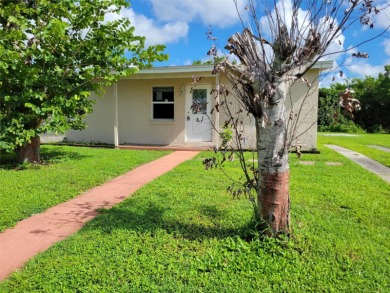 Solidly-constructed, compact home with tile floors throughout on Port Charlotte Golf Club in Florida - for sale on GolfHomes.com, golf home, golf lot