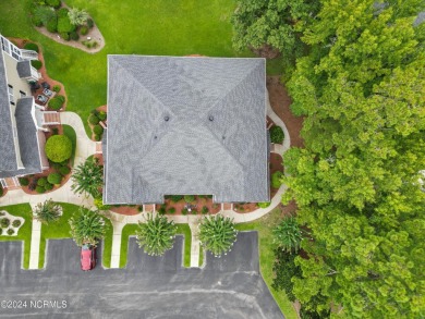 Sit on your enclosed porch and watch the golfers, gators, and on Sea Trail Golf Resort in North Carolina - for sale on GolfHomes.com, golf home, golf lot