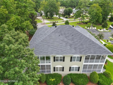 Sit on your enclosed porch and watch the golfers, gators, and on Sea Trail Golf Resort in North Carolina - for sale on GolfHomes.com, golf home, golf lot