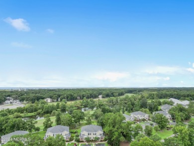 Sit on your enclosed porch and watch the golfers, gators, and on Sea Trail Golf Resort in North Carolina - for sale on GolfHomes.com, golf home, golf lot