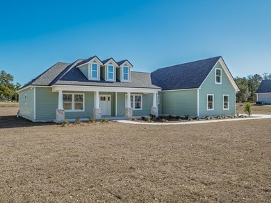 Move-in Ready! Exquisite new construction overlooking hole 6 of on Wildwood Country Club in Florida - for sale on GolfHomes.com, golf home, golf lot