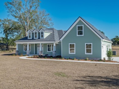 Move-in Ready! Exquisite new construction overlooking hole 6 of on Wildwood Country Club in Florida - for sale on GolfHomes.com, golf home, golf lot