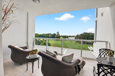 Dazzling golf and sparkling lake views await in this stunning on Boca West Golf and Country Club in Florida - for sale on GolfHomes.com, golf home, golf lot