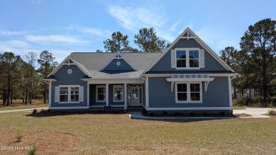 Discover the Skiff, a beautiful new Logan Home, located in on Sea Trail Golf Resort in North Carolina - for sale on GolfHomes.com, golf home, golf lot