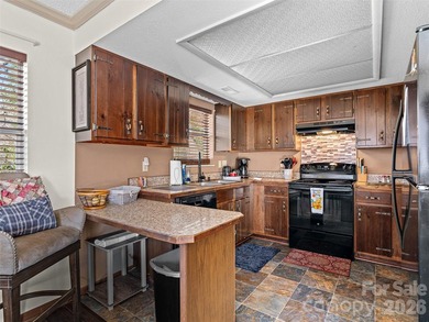 Positioned above Maggie Valley Club & Resort, this 2 bedroom, 2 on Maggie Valley Resort and Country Club in North Carolina - for sale on GolfHomes.com, golf home, golf lot