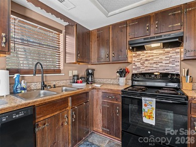 Positioned above Maggie Valley Club & Resort, this 2 bedroom, 2 on Maggie Valley Resort and Country Club in North Carolina - for sale on GolfHomes.com, golf home, golf lot