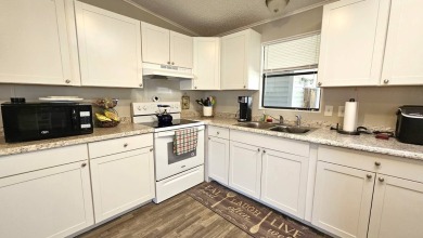 Welcome to paradise in this stunning 2-bedroom, 2-bathroom home on Blue Heron Pines Golf Course in Florida - for sale on GolfHomes.com, golf home, golf lot