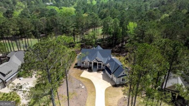 Indulge in opulent living within this custom 5-bedroom, 5.5-bath on Reynolds Lake Oconee - The Oconee in Georgia - for sale on GolfHomes.com, golf home, golf lot