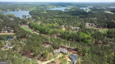 Indulge in opulent living within this custom 5-bedroom, 5.5-bath on Reynolds Lake Oconee - The Oconee in Georgia - for sale on GolfHomes.com, golf home, golf lot