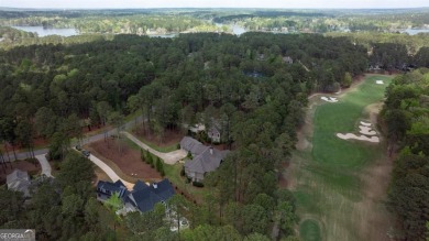 Indulge in opulent living within this custom 5-bedroom, 5.5-bath on Reynolds Lake Oconee - The Oconee in Georgia - for sale on GolfHomes.com, golf home, golf lot