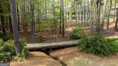 Indulge in opulent living within this custom 5-bedroom, 5.5-bath on Reynolds Lake Oconee - The Oconee in Georgia - for sale on GolfHomes.com, golf home, golf lot