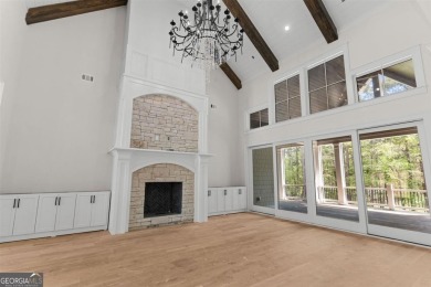 Indulge in opulent living within this custom 5-bedroom, 5.5-bath on Reynolds Lake Oconee - The Oconee in Georgia - for sale on GolfHomes.com, golf home, golf lot