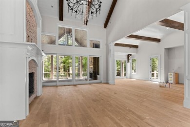 Indulge in opulent living within this custom 5-bedroom, 5.5-bath on Reynolds Lake Oconee - The Oconee in Georgia - for sale on GolfHomes.com, golf home, golf lot