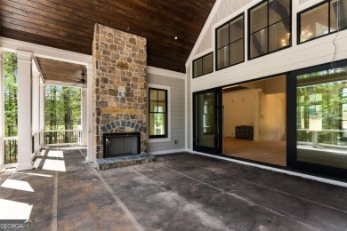 Indulge in opulent living within this custom 5-bedroom, 5.5-bath on Reynolds Lake Oconee - The Oconee in Georgia - for sale on GolfHomes.com, golf home, golf lot