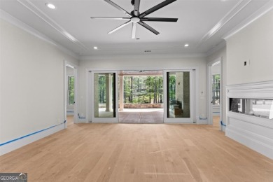 Indulge in opulent living within this custom 5-bedroom, 5.5-bath on Reynolds Lake Oconee - The Oconee in Georgia - for sale on GolfHomes.com, golf home, golf lot