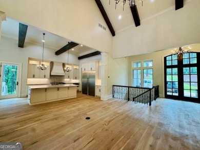 Indulge in opulent living within this custom 5-bedroom, 5.5-bath on Reynolds Lake Oconee - The Oconee in Georgia - for sale on GolfHomes.com, golf home, golf lot