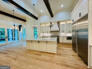 Indulge in opulent living within this custom 5-bedroom, 5.5-bath on Reynolds Lake Oconee - The Oconee in Georgia - for sale on GolfHomes.com, golf home, golf lot