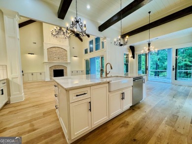 Indulge in opulent living within this custom 5-bedroom, 5.5-bath on Reynolds Lake Oconee - The Oconee in Georgia - for sale on GolfHomes.com, golf home, golf lot