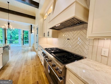Indulge in opulent living within this custom 5-bedroom, 5.5-bath on Reynolds Lake Oconee - The Oconee in Georgia - for sale on GolfHomes.com, golf home, golf lot