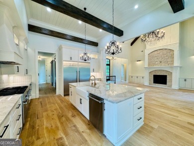 Indulge in opulent living within this custom 5-bedroom, 5.5-bath on Reynolds Lake Oconee - The Oconee in Georgia - for sale on GolfHomes.com, golf home, golf lot