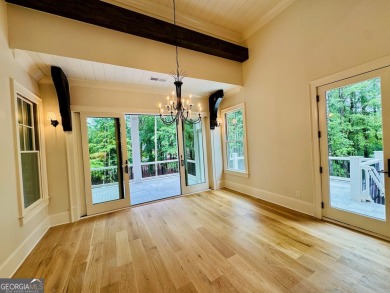 Indulge in opulent living within this custom 5-bedroom, 5.5-bath on Reynolds Lake Oconee - The Oconee in Georgia - for sale on GolfHomes.com, golf home, golf lot