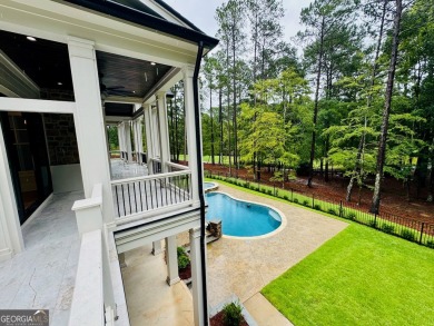 Indulge in opulent living within this custom 5-bedroom, 5.5-bath on Reynolds Lake Oconee - The Oconee in Georgia - for sale on GolfHomes.com, golf home, golf lot
