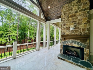 Indulge in opulent living within this custom 5-bedroom, 5.5-bath on Reynolds Lake Oconee - The Oconee in Georgia - for sale on GolfHomes.com, golf home, golf lot