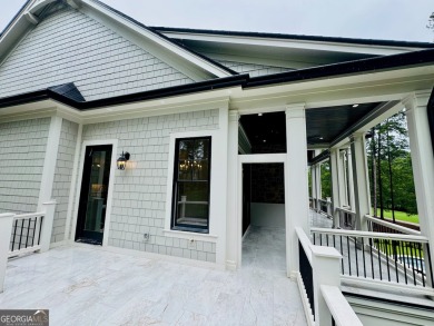 Indulge in opulent living within this custom 5-bedroom, 5.5-bath on Reynolds Lake Oconee - The Oconee in Georgia - for sale on GolfHomes.com, golf home, golf lot