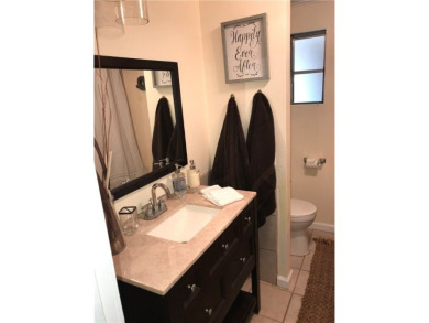 This cozy corner-lot home is full of potential and ready for on Barefoot Bay Golf Course in Florida - for sale on GolfHomes.com, golf home, golf lot