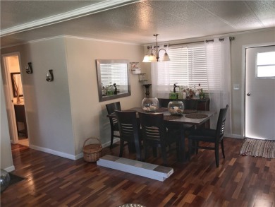 This cozy corner-lot home is full of potential and ready for on Barefoot Bay Golf Course in Florida - for sale on GolfHomes.com, golf home, golf lot